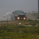 A truck drives along a road that has been washed out in Alligator Point, Florida.